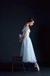 © master1305 - Portrait of the classical ballerina in white dress on black background