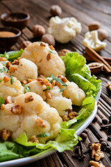 Wall Mural - Vegetarian cauliflower with lettuce, walnuts, cinnamon, ground cloves, pepper and parsley