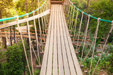 Fototapeta Dziecięca - Suspension bridge, walkway to the adventurous, cross to the other side forest