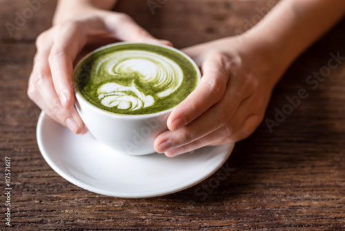 Cuadros en Lienzo hand holding matcha green tea latter