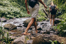 Couple Crossing The Stream Barefooted