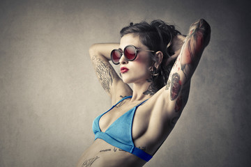 Wall Mural - Tattooed woman wearing a swimsuit