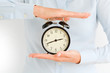 © adrian_ilie825 - Businesswoman holding an old clock in hands suggesting deadline concept