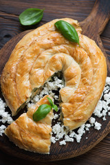 Wall Mural - Burek pie with cheese and spinach stuffing, above view, close-up