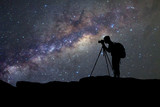 Fototapeta  - silhouette  of man photography take a photo of Milky Way galaxy