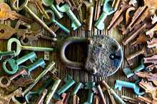 Old Rusty Padlock And Keys On Wooden Background