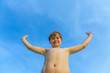© travelview - boy at beach rises up his arms