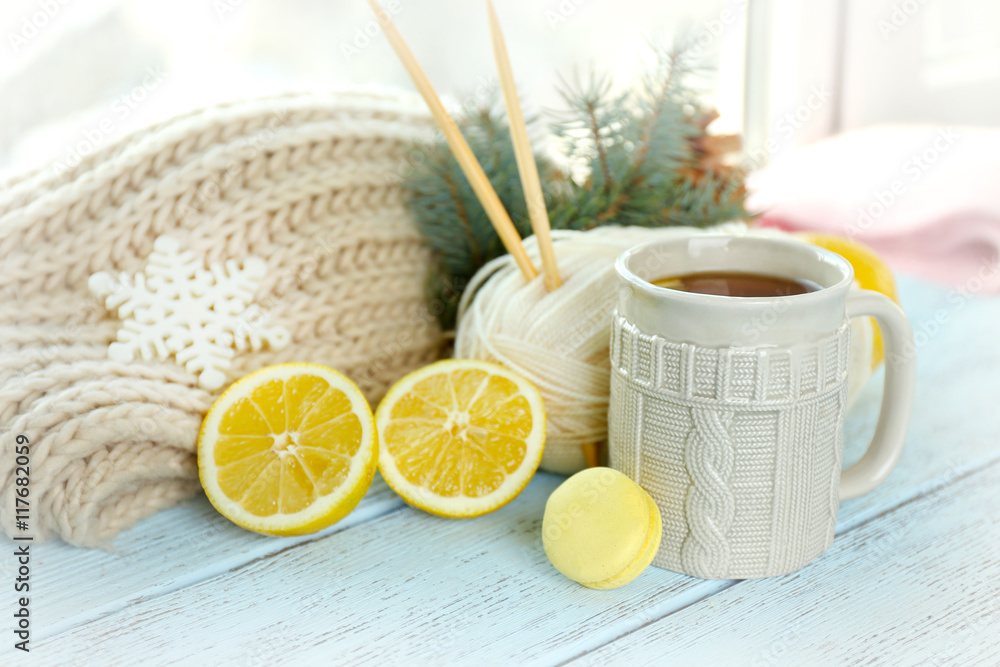 Beautiful winter composition on windowsill with cup of hot drink