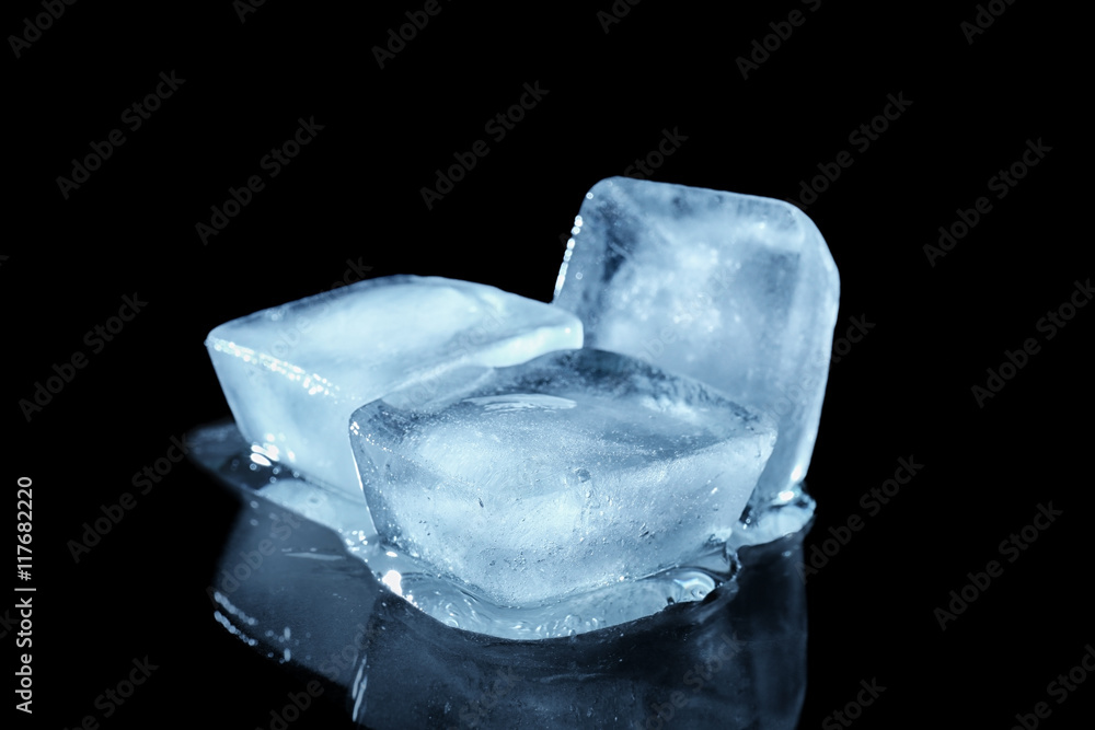 Melting ice cubes on dark background