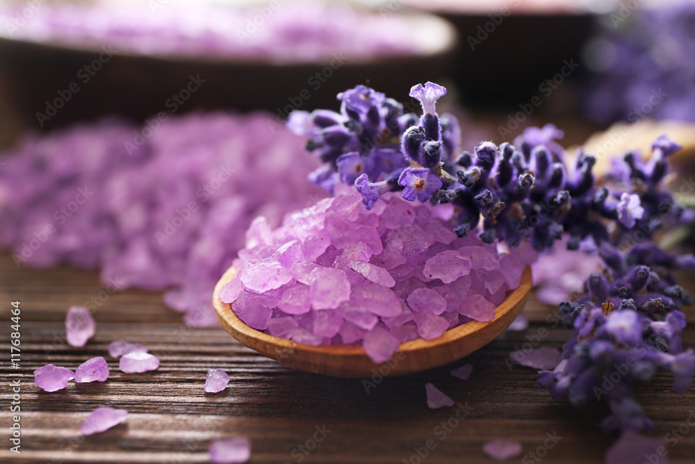 Purple sea salt with lavender on wooden background