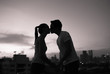© kieferpix - Young couple in the city kissing on a roof top.
