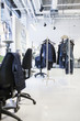 © Astrakan Images - Jeans hanging from racks in factory