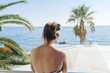 © Astrakan Images - Rear view of woman looking at sea
