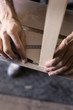 © Astrakan Images - Close-up of carpenter's hands marking on wood
