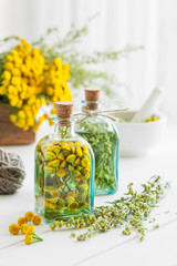 Wall Mural - Tincture bottles of tansy and tarragon healthy herbs