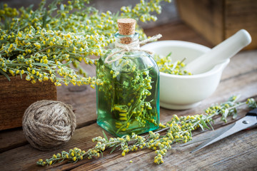 Wall Mural - Bottle of absent or tincture of tarragon healthy herbs