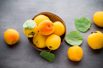 Apricots on a grey metal background.