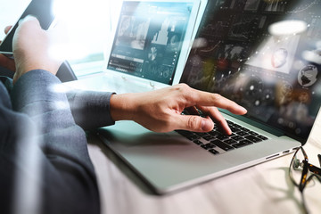 businessman hand working on laptop computer with digital layer b