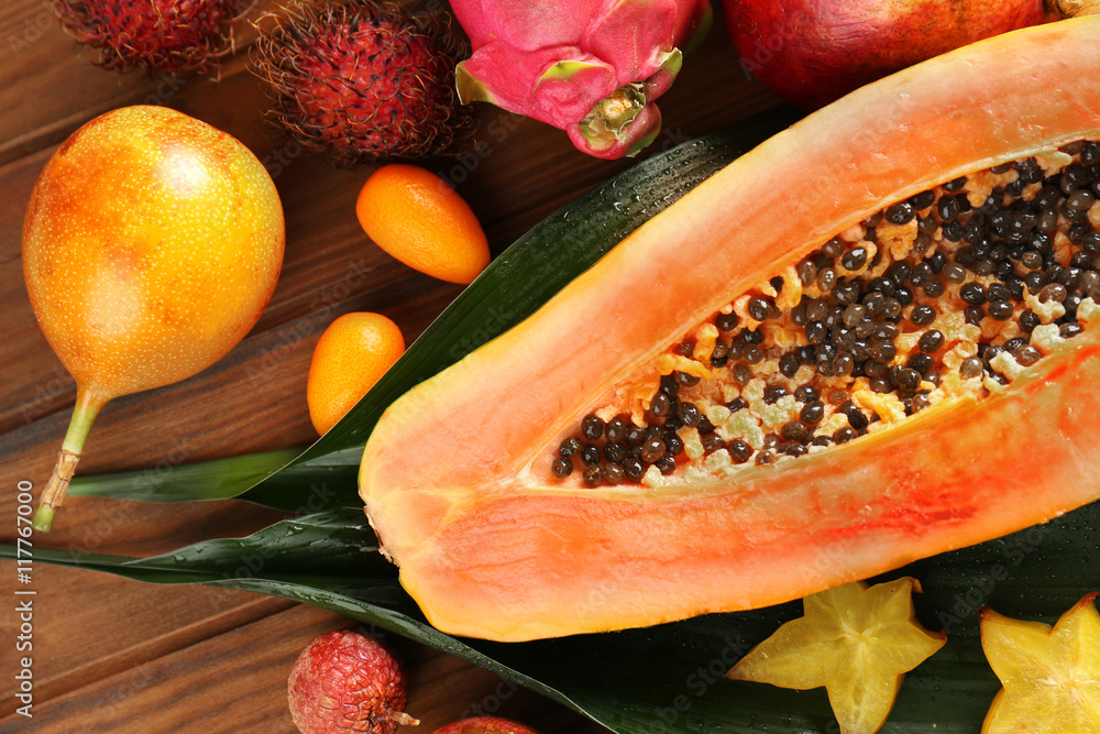 Tasty exotic fruits on wooden background