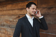 © Davidovici - Attractive businessman talking on mobile phone and smiling.