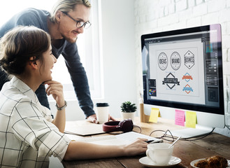Wall Mural - design working using computer discussing concept