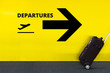 Airport Sign With Departures Airplane Icon on the Yellow Wall. Passenger Rolling the Luggage in Motion