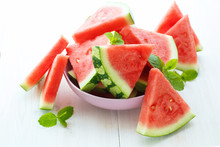 Triangular Slices Of Fresh Watermelon On White Wooden Background