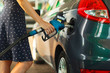 © vladstar - Woman fills petrol into her car