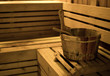 © sucharn - sauna bucket in wooden sauna room.