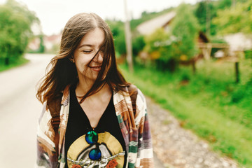 stylish hipster woman smiling and relaxing, calm mood in sunny