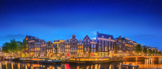 Wall Mural - Amstel river, canals and night view of beautiful Amsterdam city. Netherlands