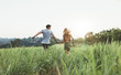Young couple running on meadow