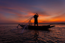 Silhouette Of Traditional Fishermen Throwing Net Fishing Inle Lake At Sunrise Time, Myanmar