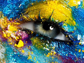 Wall Mural - Beauty, cosmetics and makeup. Magic eyes look with bright creative make-up. Macro shot of beautiful woman's face with perfect art make up. Closeup of female eye. Body art