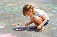 Little Girl Draws A Chalk