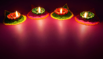 Wall Mural - Colorful clay diya lamps lit during diwali celebration