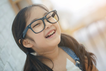 Wall Mural - Happy Asian girl enjoy eating soft ice-cream