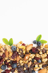 Wall Mural - homemade granola, almond, raisins, fresh blueberry, cranberry, healthy breakfast on white table background.
