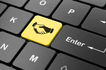 Business concept: Handshake on computer keyboard background