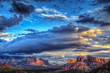 The last rays of sunlight over Sedona Arizona with a building storm moving in.