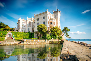 View on Miramare castle on the gulf of Trieste on northeastern Italy. Long exposure image technic with reflection on the water