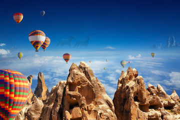 Canvas Print - Hot air balloons, hand carved rooms in rocks, two running horses