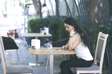 Canvas Print - Woman holding  phone in a cafe