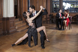Tango Dancers Performing While Couple Dating In Restaurant