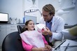© WavebreakMediaMicro - Dentist showing model teeth to patient