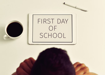 Wall Mural - teacher and text first day of school in a tablet