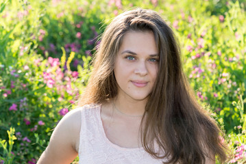 Portrait of girl of 16 years in flower meadow