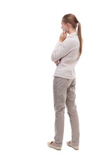 Back View Of Standing Young Beautiful  Woman.  Girl  Watching. Rear View People Collection.  Backside View Of Person.  Girl With Long Hair In A White Jacket Standing Sideways Resting His Chin.