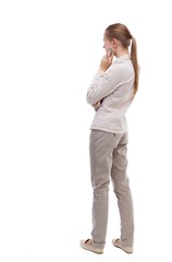 Wall Mural - back view of standing young beautiful  woman.  girl  watching. Rear view people collection.  backside view of person.  Girl with long hair in a white jacket standing sideways resting his chin.