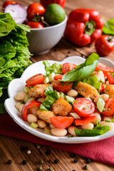 Poster -  Vegetable salad with white beans, fried fish pieces, red pepper, green onion and chive